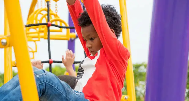 divorce in Oregon with child represented by picture of a kid in Oregon on playground looking sad