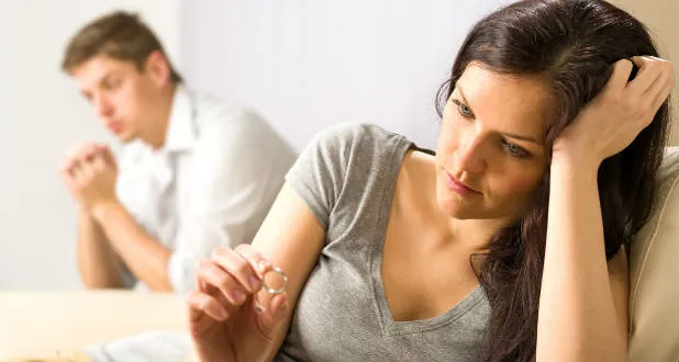 Should I get a divorce? Picture of wife looking at ring, contemplating the decision to divorce.