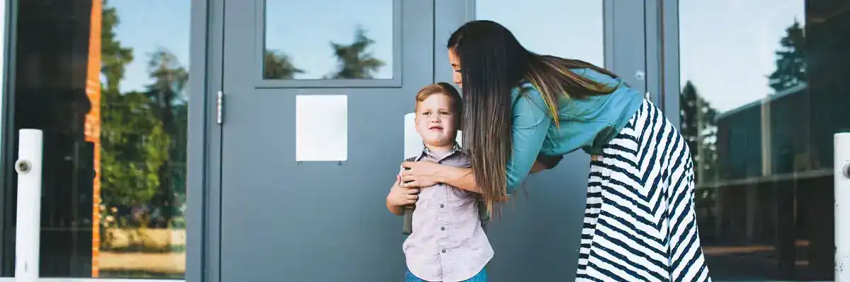 Mom leaving son at door for custody schedule exchange.