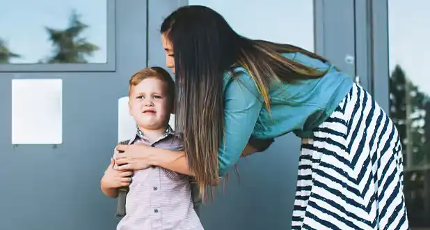 Mom dropping off child for a parenting schedule transition.